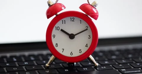 Red alarm clock for ten o'clock on computer keyboard Stock Footage 209461189