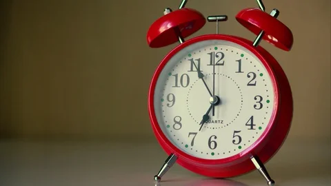 Red alarm clock on a white nightstand, time 6:55 Stock Footage 128486781