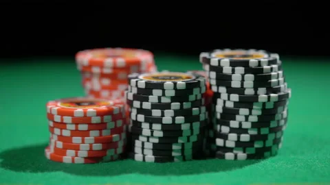 Red and black chip stacks on green gaming table. Man playing bet all in. Vídeo Stock 235391720