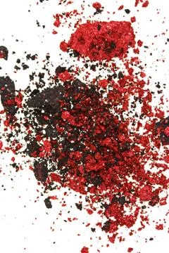 Red and black color crumbled eye shadows isolated on white Stock Photos