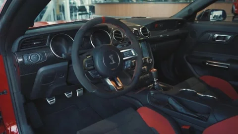 Red and Black Leather Interior of a Ford Mustang Shelby in Showroom. Stock Footage