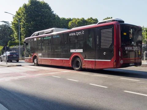 Red and black methane powered public transport bus driving on a city street i Stock Photos