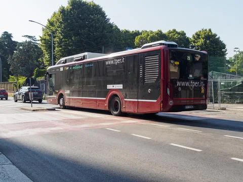 Red and black methane powered public transport bus driving on a city street i Stock Photos