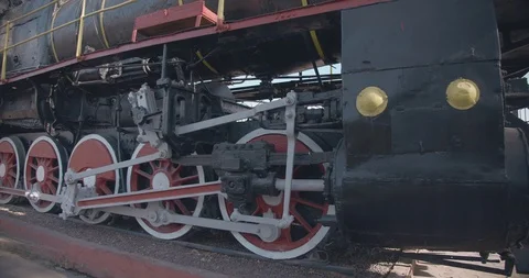 Red and black wheels of the old black Soviet steam engine train locomotive Stock Footage 127160121