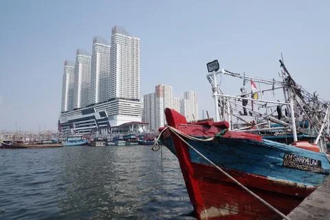 Red and blue boat rigging against high rise towers Stock Photos