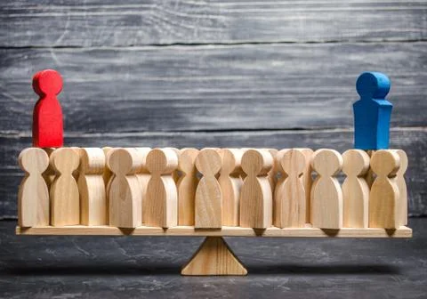 Red and blue figurines stand over a crowd of people. The rivalry of two peopl Stock Photos