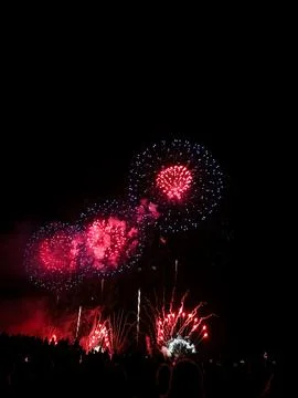 Red and blue fireworks exploding over crowd at 22 July Cannes Fotos de archivo
