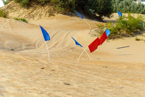 Red and blue flags to limit the race track to the sand Stock Photos