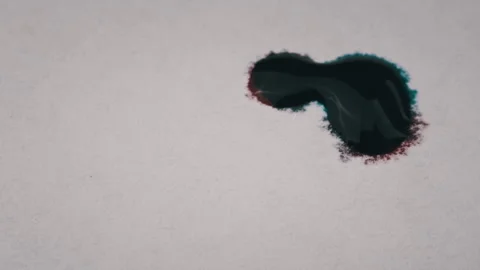 Red and Blue Ink Drops Fall on a White Sheet of Paper and Mix Close-Up Stock Footage 201338714