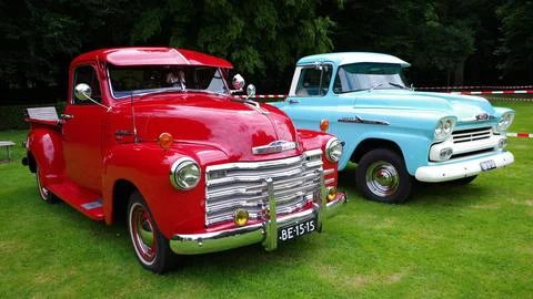 A red and a blue oldtimer pickup truck Stock Photos