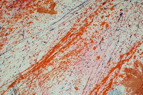 Red and blue paint splashes on grunge wall. Abstract hand painted backdrop for Stock Photos