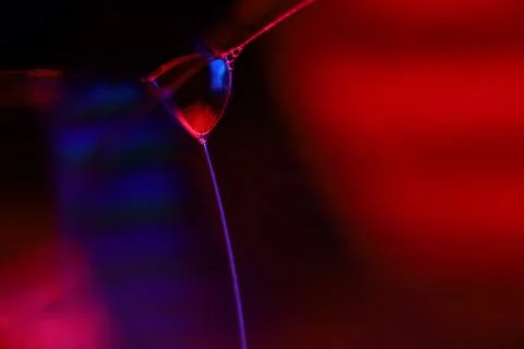 Red and blue reflections of liquid in macro, water surface 写真素材