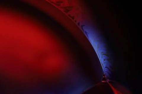 Red and blue reflections of liquid in macro, water surface Stock Photos