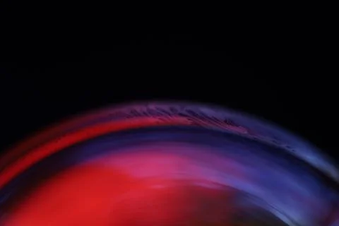 Red and blue reflections of liquid in macro, water surface Stock Photos