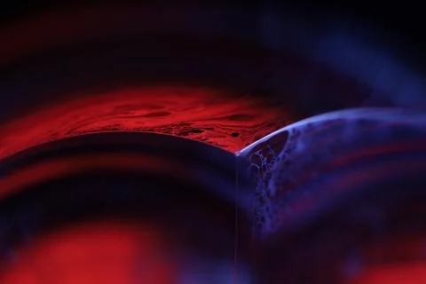 Red and blue reflections of liquid in macro, water surface 写真素材