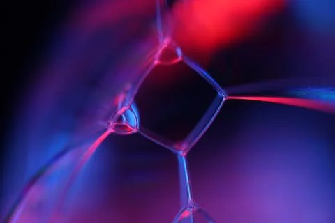 Red and blue reflections of liquid in macro, water surface Stock Photos