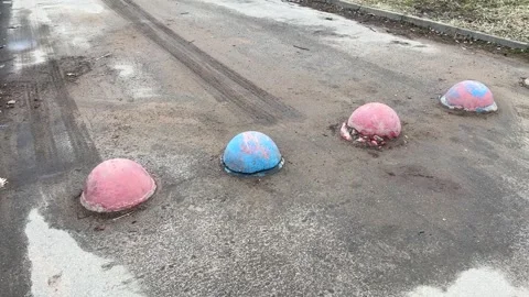 Red and blue restrictive hemispheres on the asphalt road in the parking area of Stock Footage 274599863