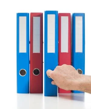 Red and blue ring binders with hand Stock Photos