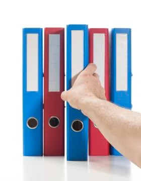 Red and blue ring binders with hand Stock Photos
