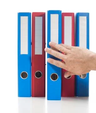 Red and blue ring binders with hand Stock Photos