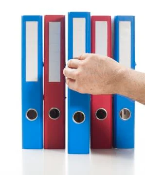 Red and blue ring binders with hand Stock Photos