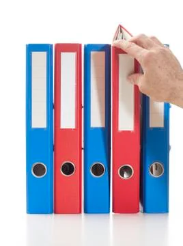 Red and blue ring binders with hand Stockfoto's