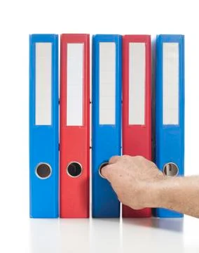 Red and blue ring binders with hand Stock Photos