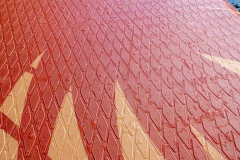 A red and brown surface with a pattern of triangles 스톡 사진