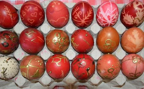 Red and gold decorated Easter eggs in carton tray on folk easter festival Stock Photos