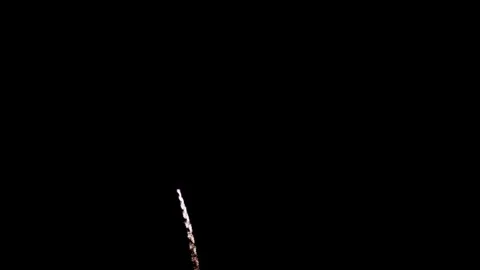 Red and gold fireworks explode against the dark sky Stock Footage 329675735