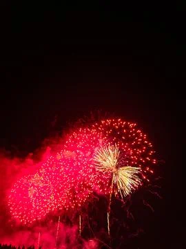Red and gold fireworks exploding in night sky at Cannes Stockfoto's