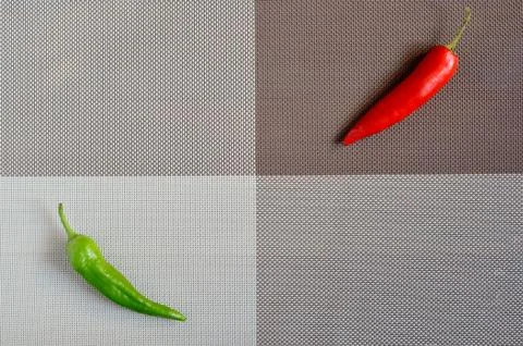 Red and green capsicum on a rectangular background of gray, brown and white Stock Photos