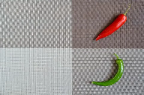 Red and green capsicum on a rectangular background of gray, brown and white Stock Photos