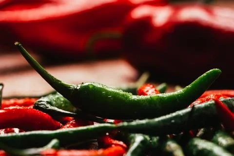 Red and green chili peppers close up on wooden background Stock Photos