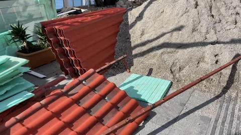 Red and green corrugated panels stacked on construction site with gravel an.. Stock Footage 331155040