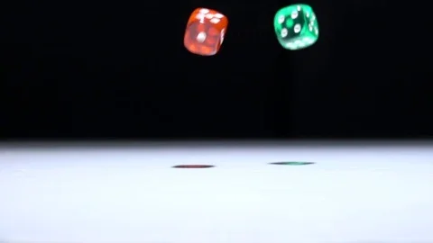 Red and green dice falling in slow motion with frozen moment. Stock Footage 70429386