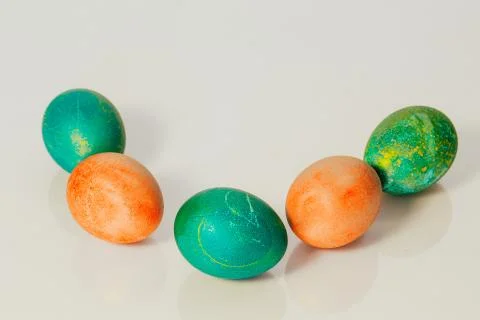 Red and green Easter eggs on white background Photos