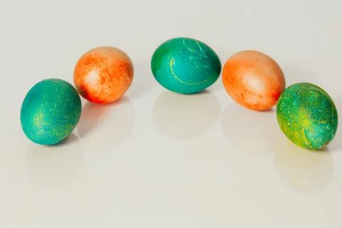 Red and green Easter eggs on white background Фото
