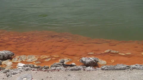 Red and green edge of geothermal lake Stock Footage