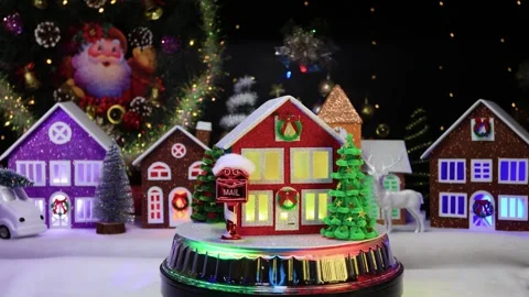 A red and green house surrounded by Christmas trees and a mailbox rotates Stock Footage 296830497