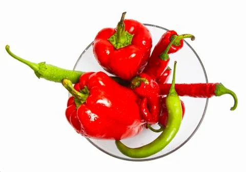 Red and green pepper composition in salad dish Stock Photos