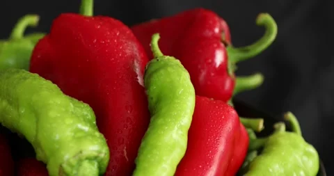 Red and green pepper rotating on black background 5 Stock Footage 139810149