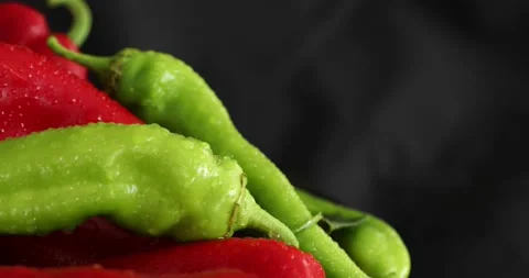 Red and green pepper rotating on black background 6 Stock Footage 139812478