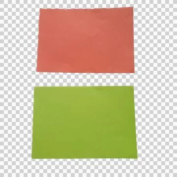 Red and green rectangular paper sheets on a flat surface Фото