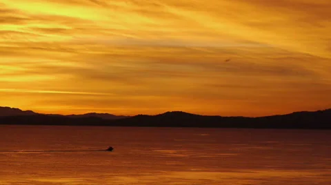 Red and Orange Sunset Over Ocean and Mountains Stock Footage 38934769