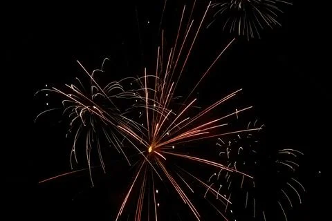 Red and pink fireworks exploding up in night Stock Photos