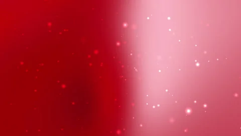 Red and pink gradient background displays scattered glowing particles Stock Footage 297605972