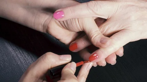 Red and pink nails of an elderly woman Stock Footage 87338613