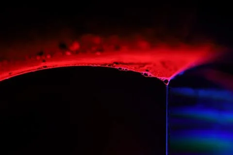 Red and purple liquid surface reflection, multicoloured art Stock Photos