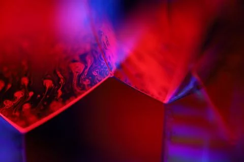 Red and purple liquid surface reflection, multicoloured art Stock Photos